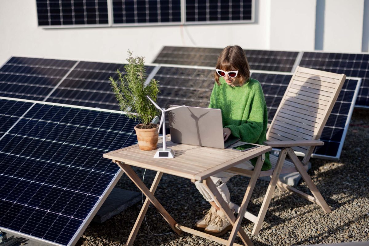 Woman works on a rooftop with a solar power plant