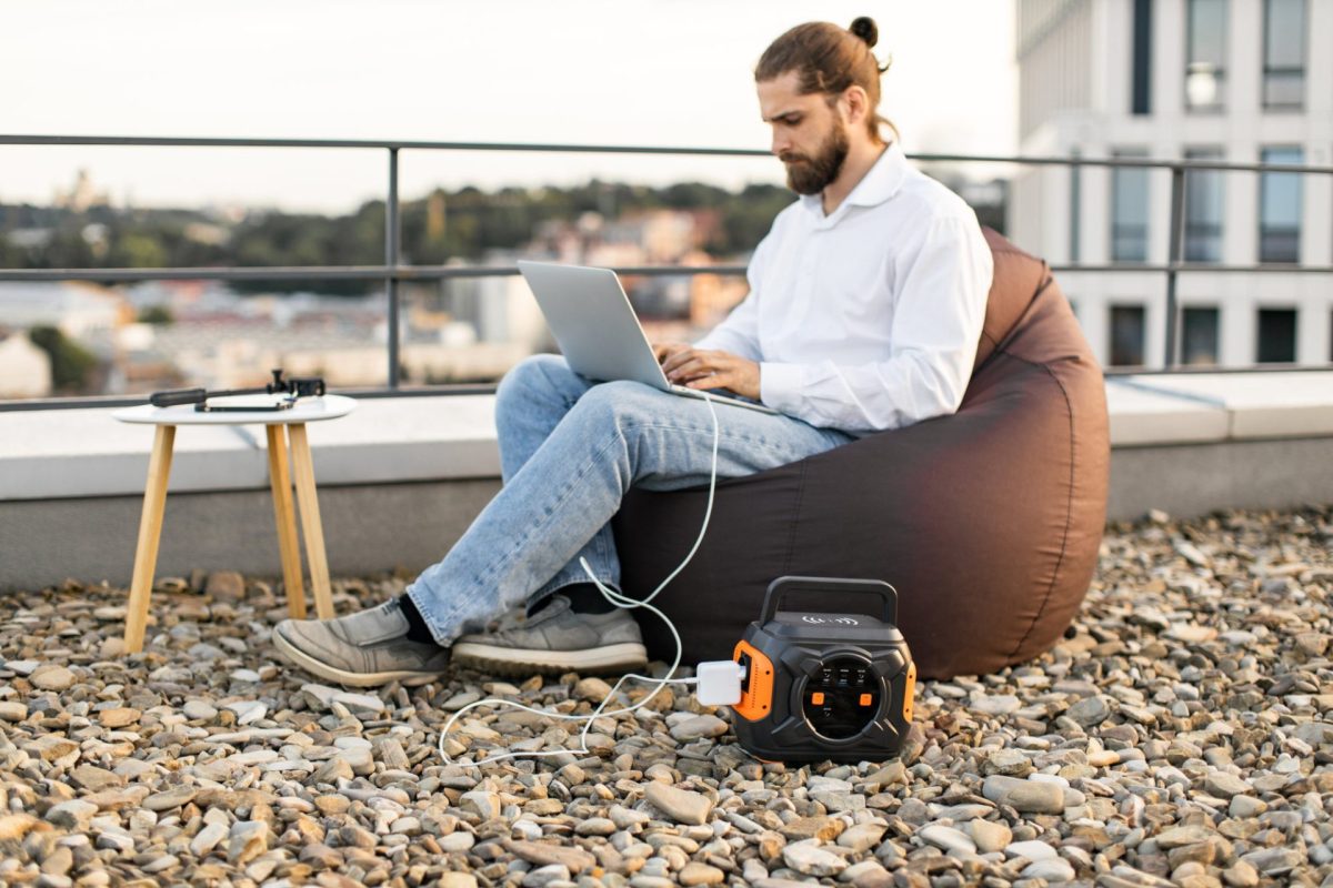 business man using portable power station on rooft 2024 12 13 14 43 11 utc