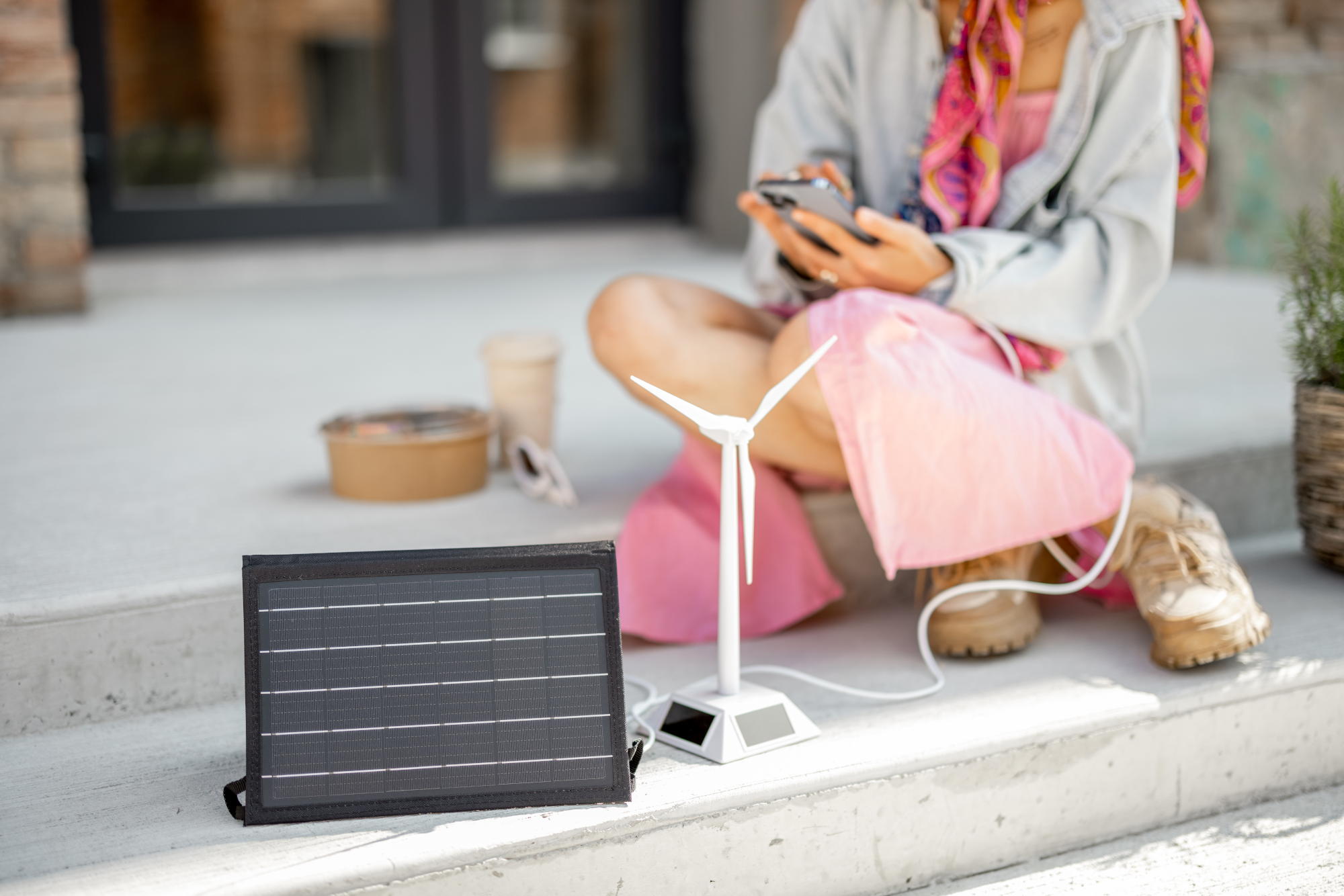 woman charge phone from a portable solar panel 2023 11 27 04 59 29 utc